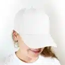 woman in white crew neck shirt wearing white cap