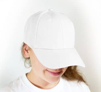 woman in white crew neck shirt wearing white cap