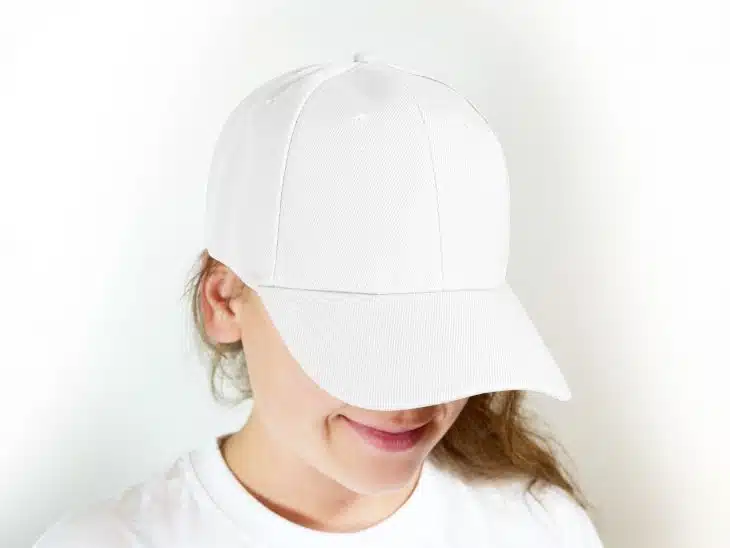 woman in white crew neck shirt wearing white cap