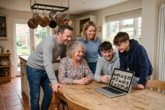 Famille multigénérationnelle réunie autour d'un ordinateur portable pour choisir des activités ensemble